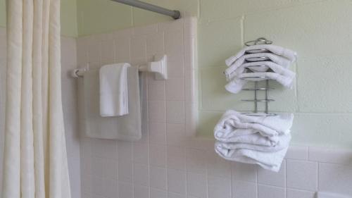 a bathroom with white towels on a towel rack at Vancouver Motel in Myrtle Beach