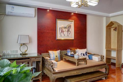 a living room with a couch and a red wall at Beijing Inner Mongolia Hotel Chaoyang in Beijing