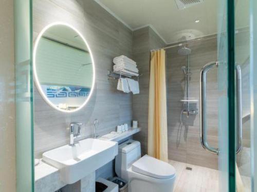 a bathroom with a toilet and a sink and a mirror at Beijing Inner Mongolia Hotel Chaoyang in Beijing