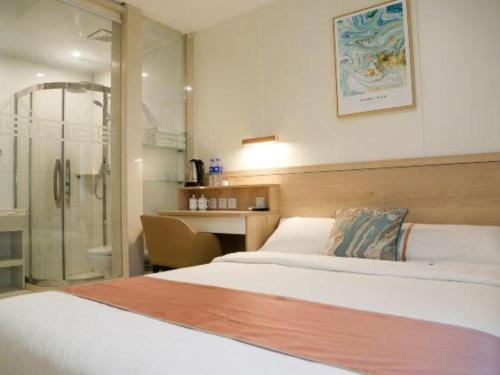 a hotel room with a bed and a shower at Beijing Inner Mongolia Hotel Chaoyang in Beijing