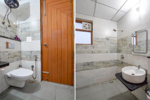 a bathroom with a toilet and a sink at FabHotel Divine & Banquet in Noida