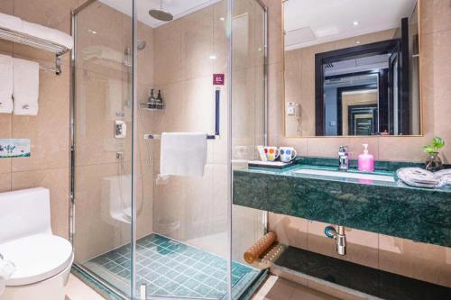 a bathroom with a shower and a sink and a toilet at Redstar Culture Hotel in Hangzhou