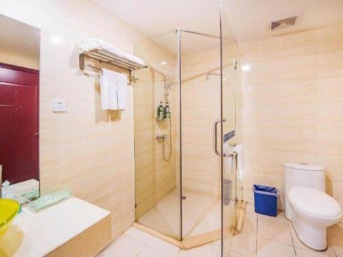 a bathroom with a shower and a toilet at Zhaoqing Shanshui Fashion Hotel Duanzhou Road Branch in Zhaoqing