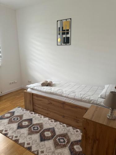 a bedroom with a bed and a rug on the floor at ZORA apartmani Sarajevo in Sarajevo