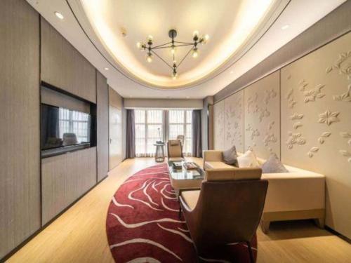 a large living room with a couch and a tv at Clear Lake Hotel in Shanwei