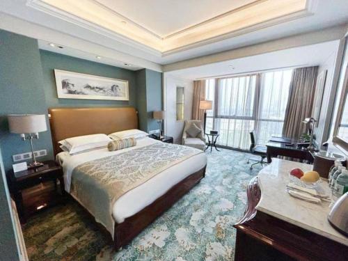 a bedroom with a large bed and a large window at Xian Jue Vu Hotel in Xi'an