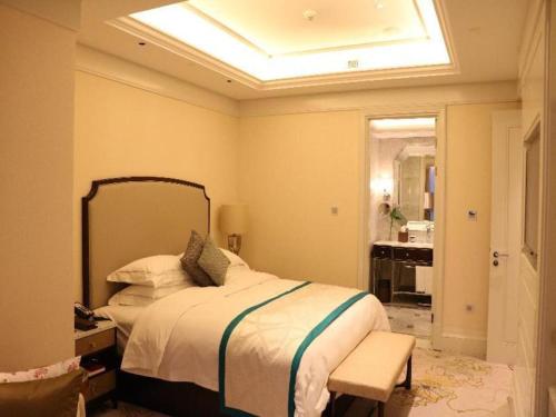 a bedroom with a bed and a bathroom with a sink at Xian Jue Vu Hotel in Xi'an