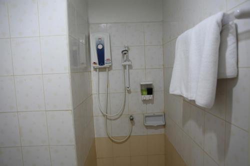 a bathroom with a shower with a hand dryer on the wall at The Residence Prachinburi in Si Maha Phot