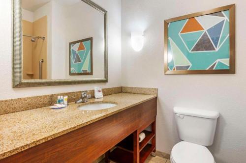 a bathroom with a sink and a toilet and a mirror at Comfort Suites in French Lick