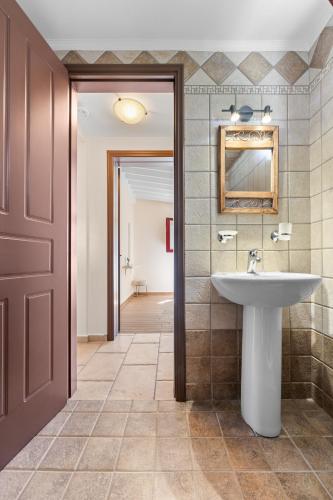 a bathroom with a sink and a mirror at A & G House Lefkada in Lefkada