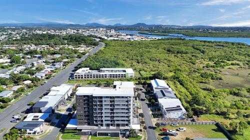 an aerial view of a city with a building at Pacific Sands Apartments Mackay in Mackay