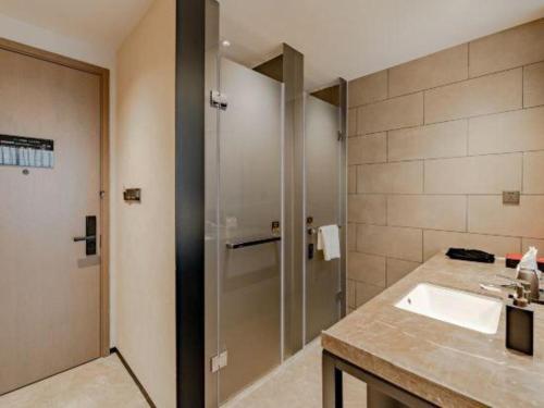 a bathroom with a sink and a shower at Dajiuhua Hotel in Chizhou