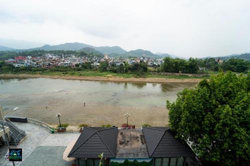 a view of a river with a city in the background at Cao Bang Eco Bistro & Stay in Cao Bằng