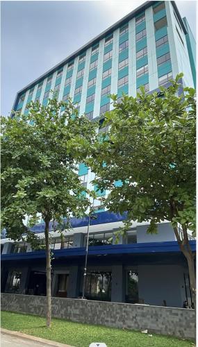 a large building with trees in front of it at ATOOI Hotel Alam Sutera in Serpong