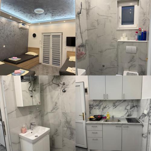a white bathroom with a sink and a shower at Apartmani Filip in Podaca