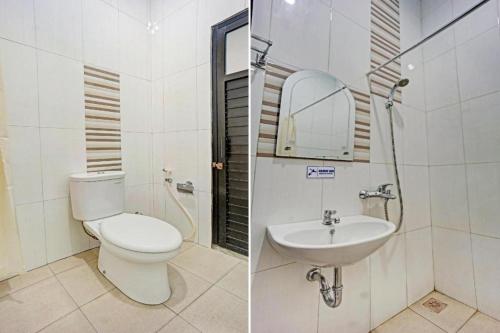 a bathroom with a toilet and a sink at Collection O 90693 ORCHID EDOTEL Boyolangu in Tulungagung