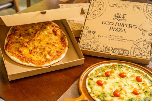 two pizzas in a box on a table at Cao Bang Eco Bistro & Stay in Cao Bằng