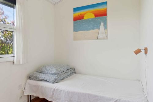 a bed in a room with a painting on the wall at Sea View, 200M To The Beach, Beautiful Nature in Slagelse