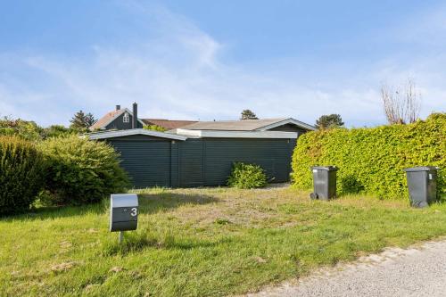 a yard with two electrical boxes in the grass at Sea View, 200M To The Beach, Beautiful Nature in Slagelse