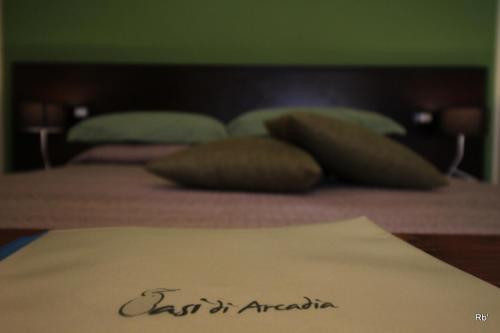 a close up of a bed with pillows on it at Oasi di Arcadia in Santa Giulia