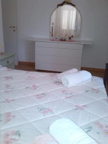 a bedroom with a bed with two towels on it at Appartamenti Claudia Rio in Rio Marina