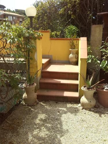 a set of stairs with potted plants in a garden at Appartamenti Claudia Rio in Rio Marina