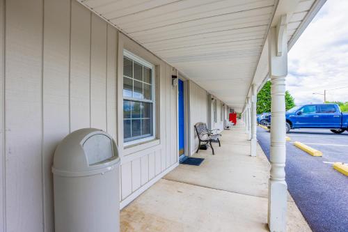 a building with a trash can on a sidewalk at Relax Inn By OYO Natural Bridge I-81 in Natural Bridge