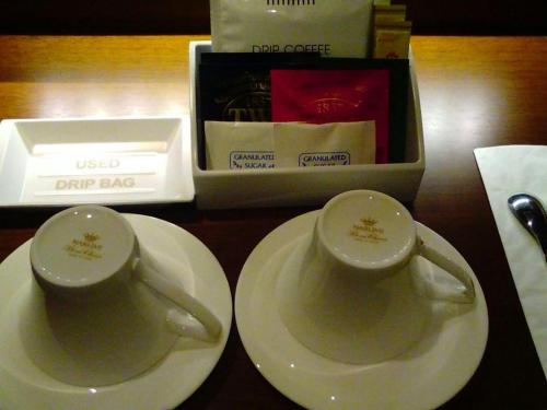 two cups and plates on a table with a box at Nippondaira Hotel in Shizuoka