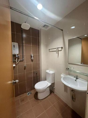 a bathroom with a toilet and a sink at Hotel Zamburger Bangsar (Previously Koptown Hotel Bangsar) in Kuala Lumpur