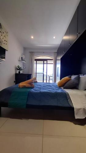a bedroom with a large bed with a large window at Aurelia Gozo Boutique BnB in Xagħra