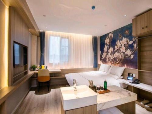 Un ou plusieurs lits dans un hébergement de l'établissement Magnotel Business Yixing Passenger Station Tuanjiu Scenic Area