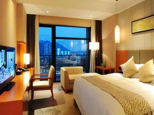 a hotel room with a bed and a large window at Suzhou Qingshan Conference Center in Suzhou