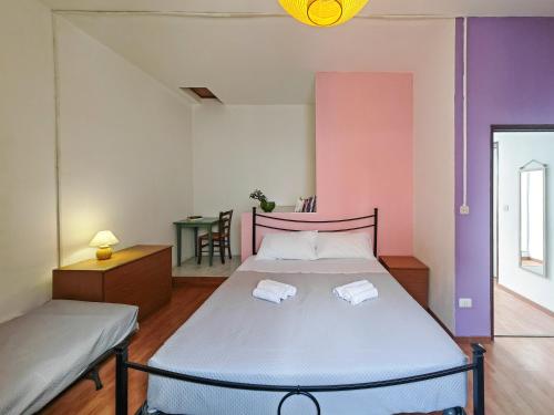a bedroom with a bed with two towels on it at Sa Posada in Cuglieri