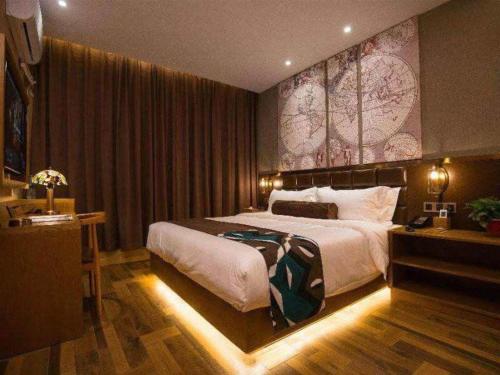 a bedroom with a large bed with a large map on the wall at James Joyce Coffetel·Kaifeng Drum Tower in Kaifeng