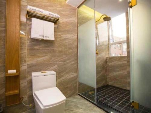 a bathroom with a toilet and a shower at James Joyce Coffetel·Kaifeng Drum Tower in Kaifeng