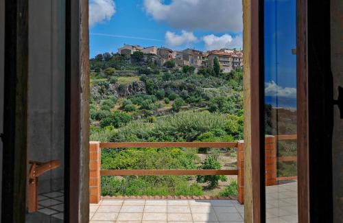 a view from the door of a balcony with a mountain at Sa Posada in Cuglieri