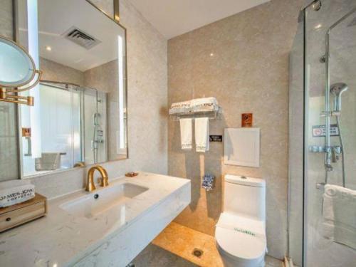 a bathroom with a sink and a toilet and a shower at James Joyce Coffetel·Lijiang Old Town Centeral in Lijiang