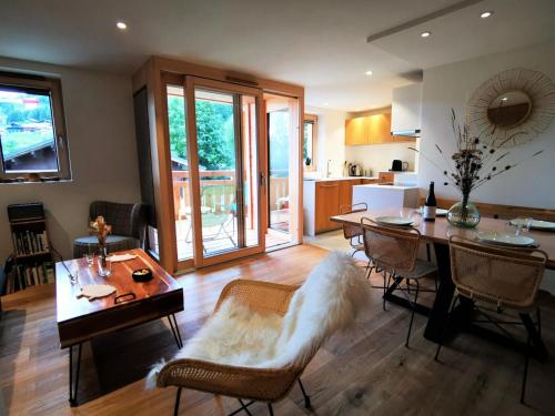 un salon avec une table et des chaises et une cuisine dans l'établissement Résidence Ambrocella - Bel appartement lumineux, exposition Sud ouest MAE-1281, aux Gets