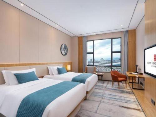 Postel nebo postele na pokoji v ubytování Longuu Hotel Zhaoqing