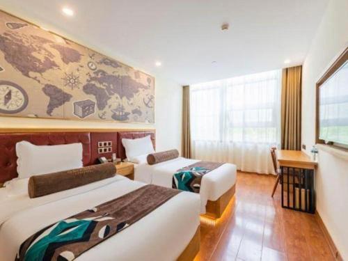 a hotel room with two beds and a map on the wall at James Joyce Coffetel Harbin Central Street in Harbin