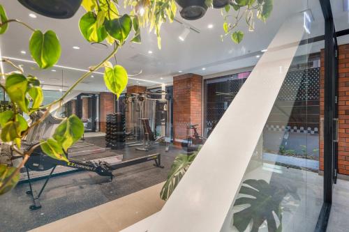 a gym with a treadmill and plants in a room at WLG CBD 1BR - Luxe Hyde Lane Stay with Amenities in Wellington