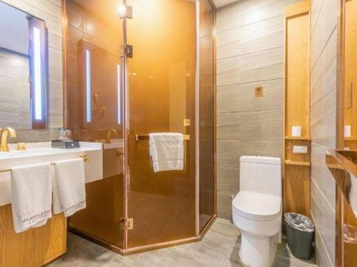 a bathroom with a shower and a toilet and a sink at James Joyce Coffetel Harbin Central Street in Harbin