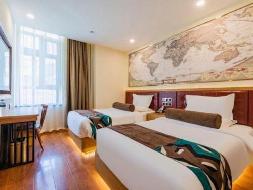 a hotel room with two beds and a map on the wall at James Joyce Coffetel Harbin Central Street in Harbin