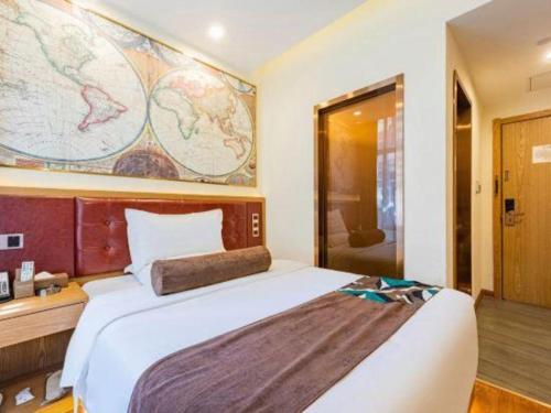 a bedroom with a large bed and a large map on the wall at James Joyce Coffetel Harbin Central Street in Harbin