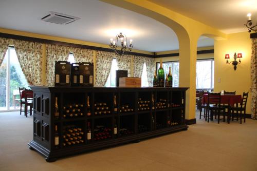 a wine cellar with a display of wine bottles at Camping Lamego Douro Valley in Lamego