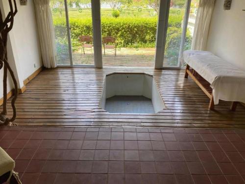 a room with a bed and a large window at Kunming Dianchi Garden Hotel & Spa in Kunming