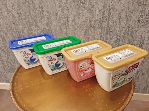 four plastic containers sitting on top of a table at Hotel Areaone Miyazaki in Miyazaki