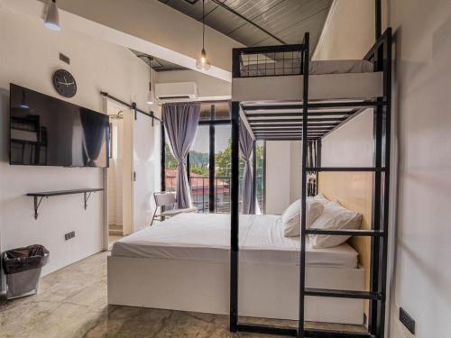 a bedroom with two bunk beds and a window at Auberge Petit Hotel in San Juan