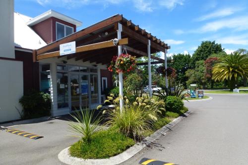 a store front with flowers and plants in a parking lot at Ramada Resort By Wyndham Rotorua Marama in Rotorua