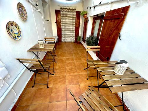 a hallway with tables and chairs in a building at Casa rural de la Abuela in Cadreita